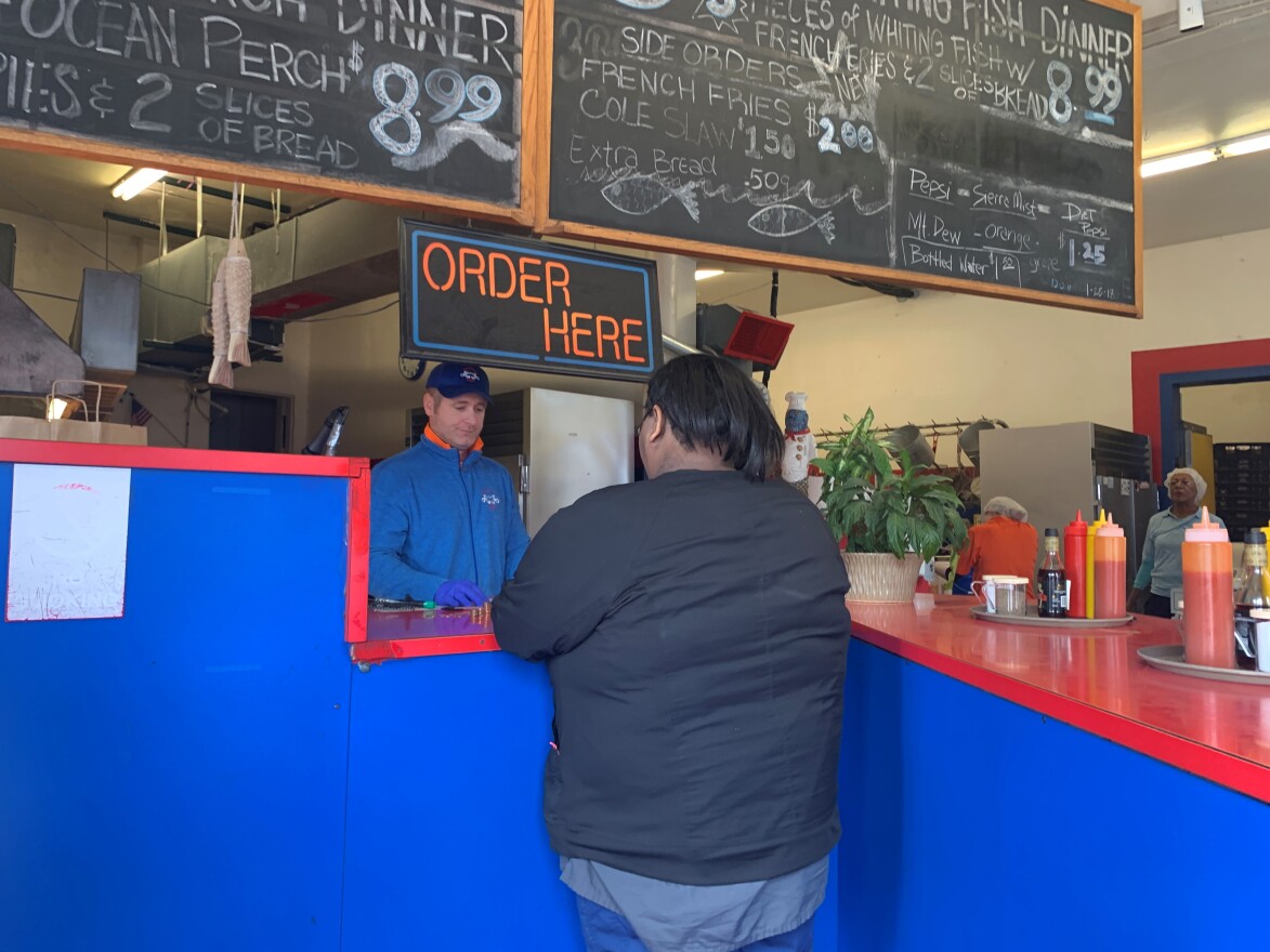 Two customers walk into Alabama Fish Bar on a recent sunny spring day in March.